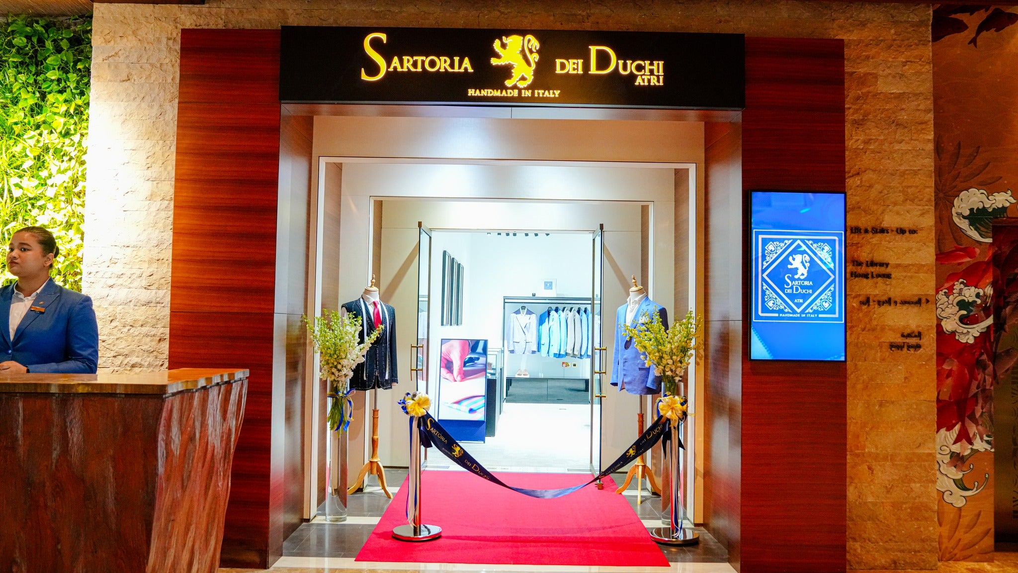 Entrance to Sartoria dei Duchi with red carpet and decorative elements