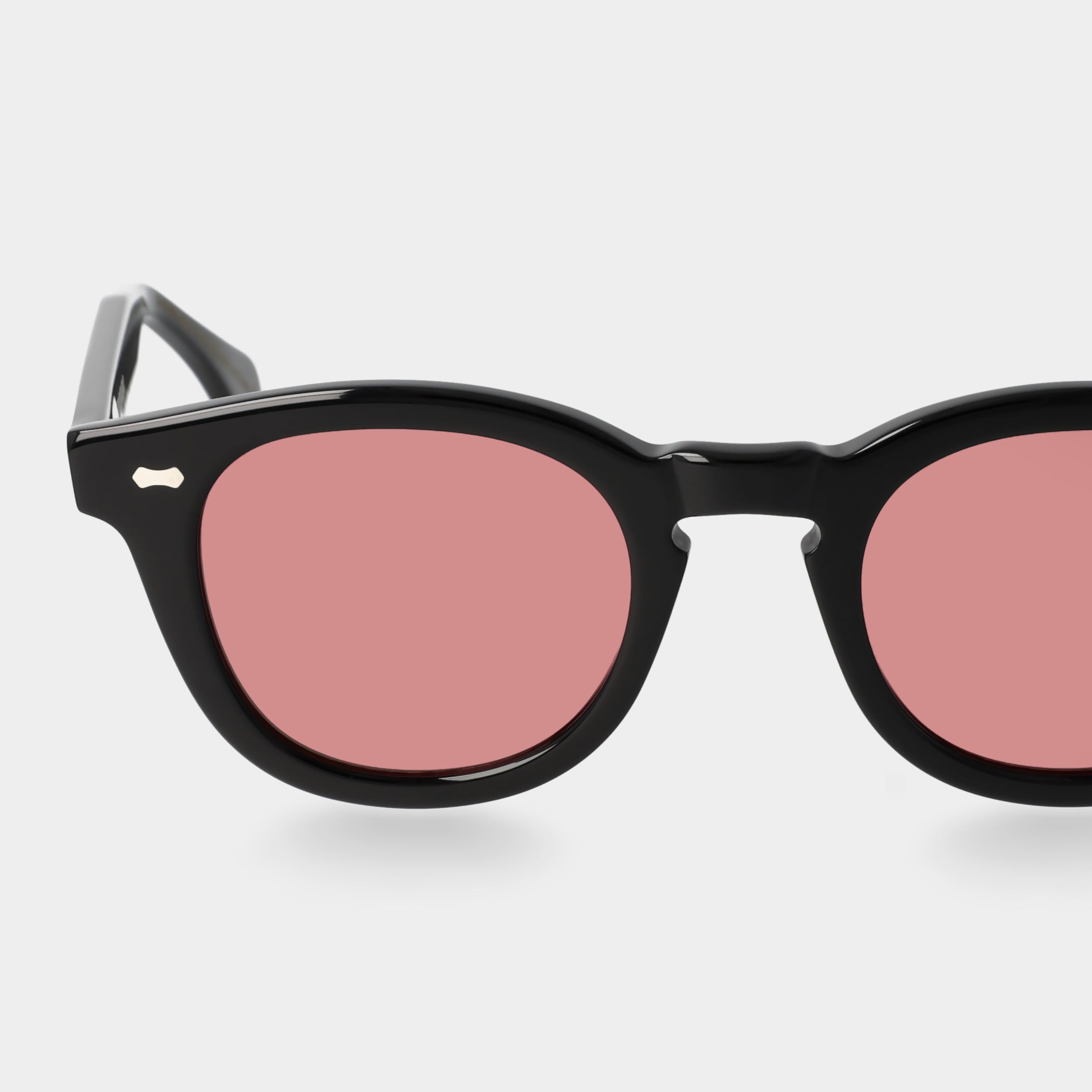 Black sunglasses with pink lenses on a white background. - DEI DUCHI
