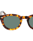 Sunglasses with tortoiseshell frame and green lenses on a white background. - DEI DUCHI