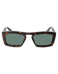 Sunglasses with tortoiseshell frame and green lenses on a light gray background. - De Duchi