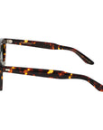 Sunglasses with tortoiseshell frame and green lenses on a light gray background. - De Duchi