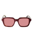 Sunglasses with red-tinted lenses on a light gray background. - Dei Duchi