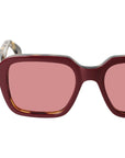 Sunglasses with red-tinted lenses on a light gray background. - Dei Duchi