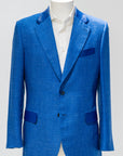 Blue suit jacket on a mannequin with a white shirt against a gray background. - Sartoia Dei-Duchi