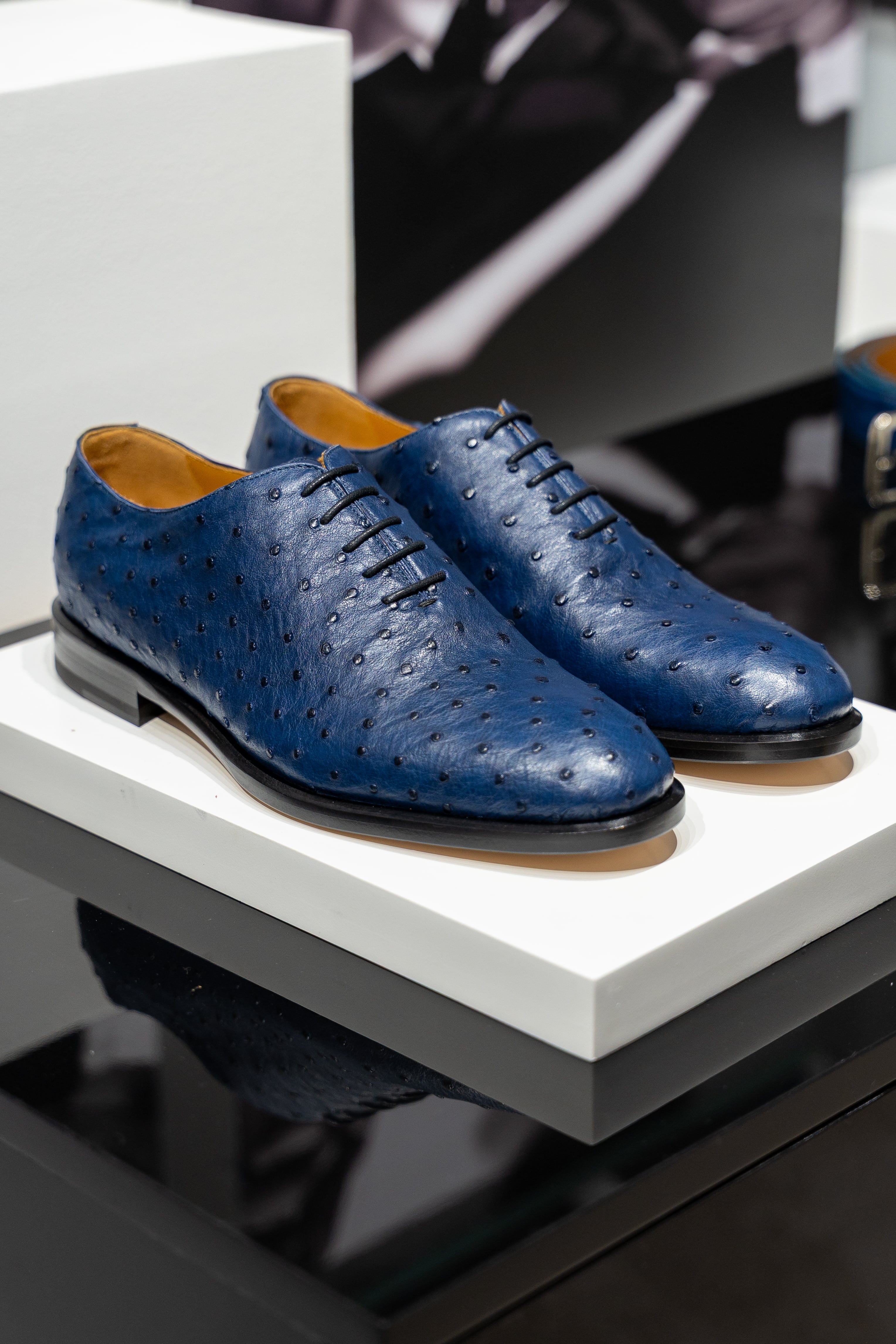 Pair of blue dress shoes on a white platform. - Sartoria Dei Duchi-Atri