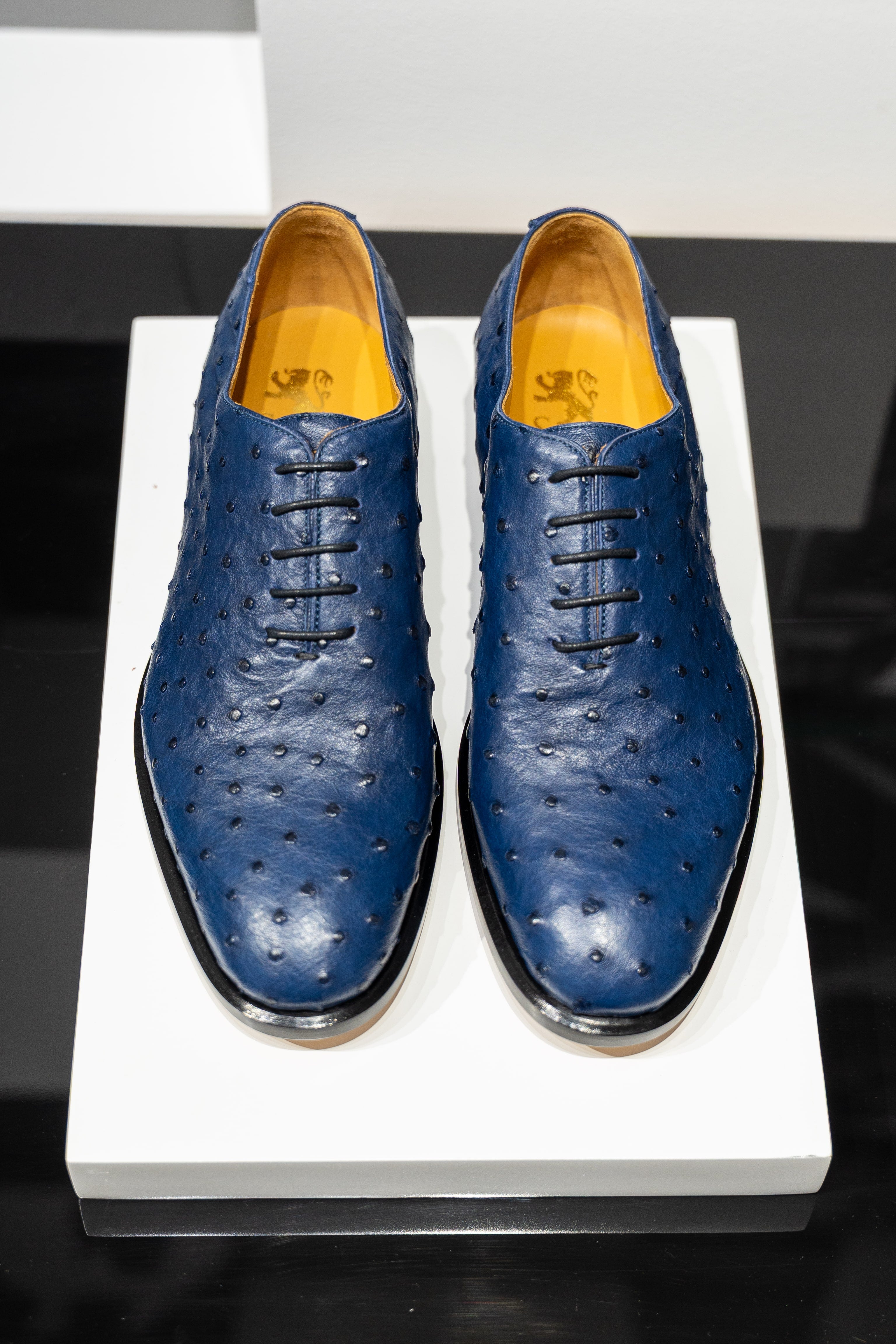 Pair of blue dress shoes on a white platform. - Sartoria Dei Duchi-Atri