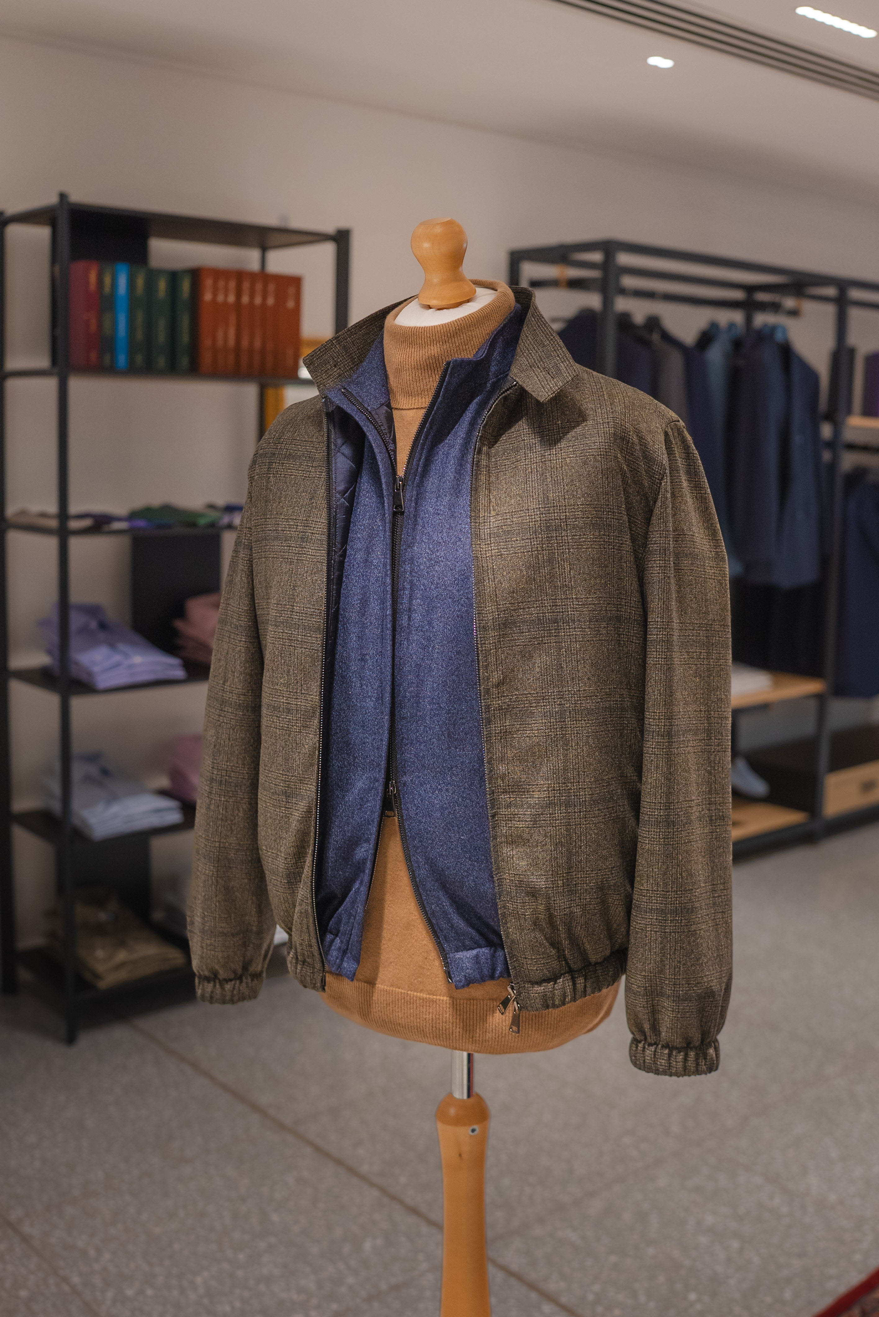 Brown jacket with blue shirt on a mannequin in a store setting. - Sartoria Dei Duchi-Atri