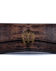 Brown embossed python skin clutch bag with gold chain and buckle/emblem on a white background. - DEI DUCHI (AMALTEA)