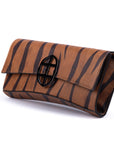 Brown leather wallet with chain strap
and embossed tiger stripe pattern and burnished metal buckle clasp on a white background. -DEI DUCHI (AMALTEA)