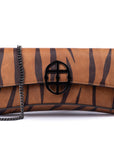 Brown leather wallet with chain strap
and embossed tiger stripe pattern and burnished metal buckle clasp on a white background. -DEI DUCHI (AMALTEA)
