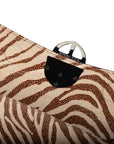 Zebra embossed pinkish leather clutch bag/wallet with a burnished metallic emblem buckle on a white background. - DEI DUCHI (AMALTEA)