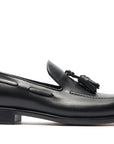 Pair of black loafers with a visible brand logo on a white background. Crust Calf. White full/grain calfskin. Tuscan tanned. Hand-dyed and antiqued leather. 9mm sole. 27mm heel height. Tuscan leather. Blake construction with bottom stitching. - Sartoria Dei Duchi - Atri