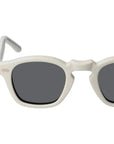 Sunglasses with white frame and dark lenses on a light gray background. - Dei Duchi