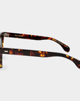 Sunglasses with tortoiseshell frame and orange lenses on a light gray background. - DEI DUCHI