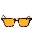 Sunglasses with tortoiseshell frame and orange lenses on a light gray background. - DEI DUCHI