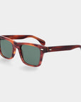 Sunglasses with tortoiseshell frame and green lenses on a light gray background. - DEI DUCHI