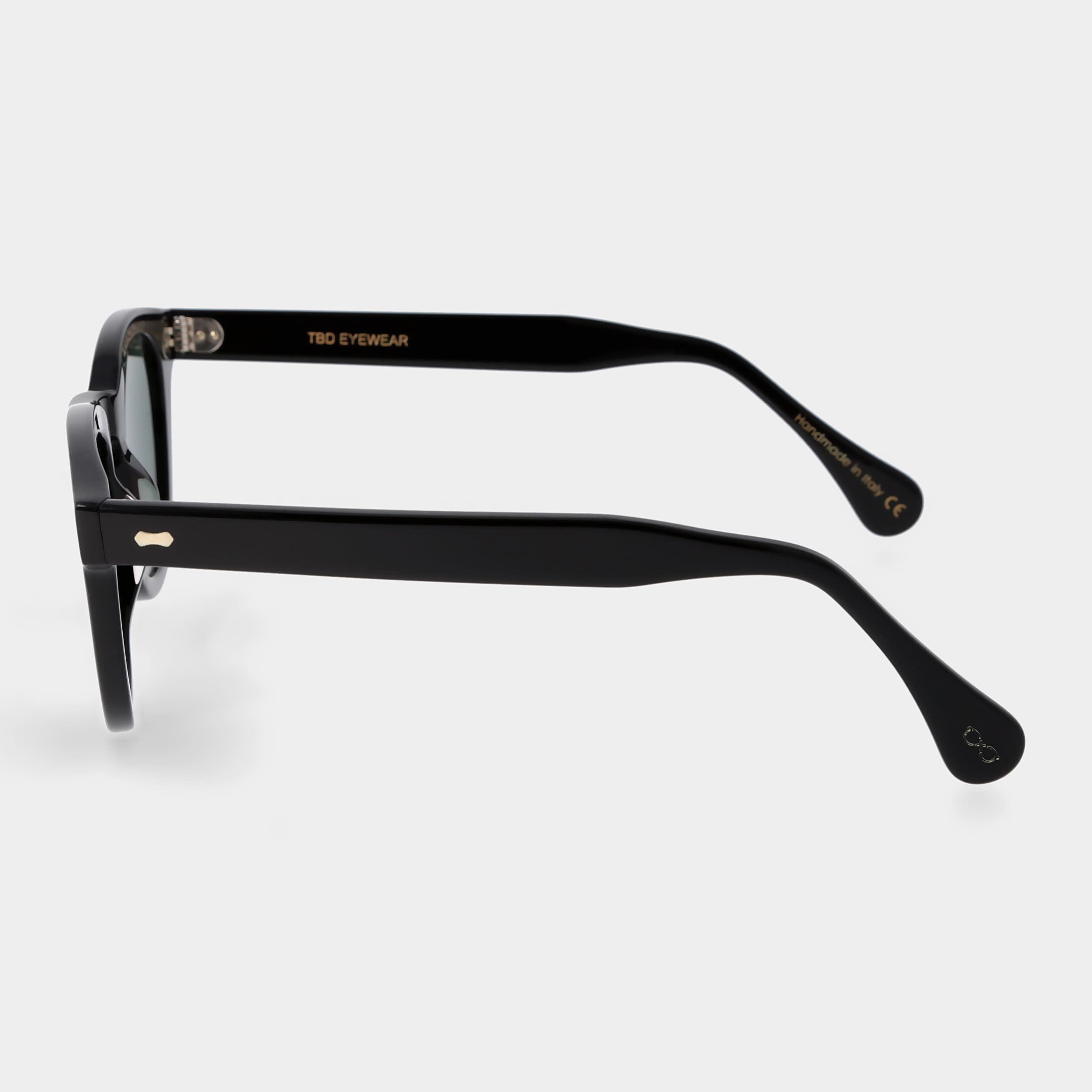 Black sunglasses with green lenses on a white background. - DEI DUCHI