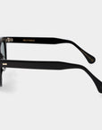 Black sunglasses with green lenses on a white background. - DEI DUCHI