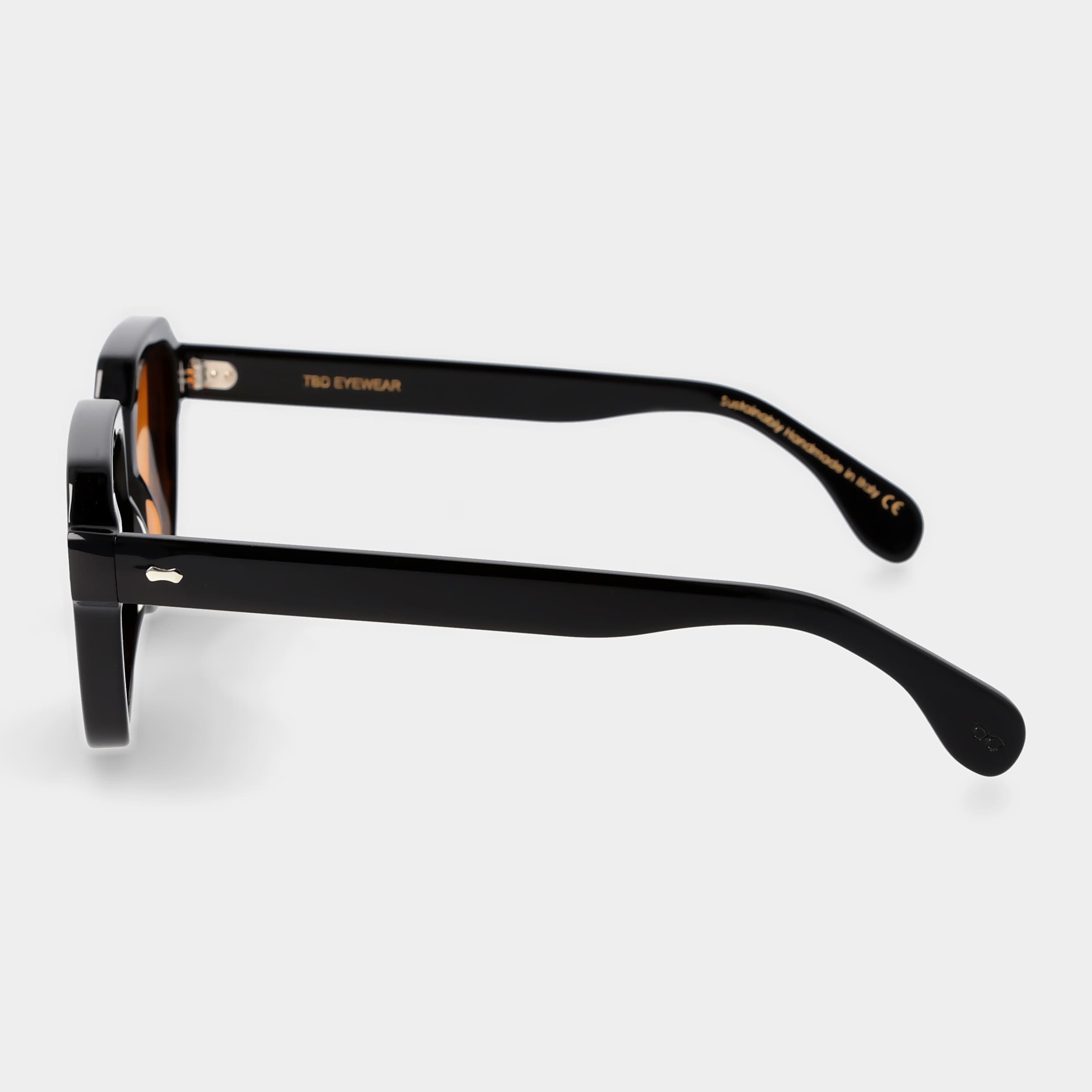 Sunglasses with yellow lenses and black frames on a white background. - DEI DUCHI