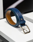 Blue leather belt with a gold buckle on a white surface. - Sartoria Dei Duchi-Atri