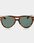 Sunglasses with tortoiseshell frame and green lenses on a light gray background. - DEI DUCHI