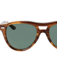 Sunglasses with tortoiseshell frame and green lenses on a light gray background. - DEI DUCHI