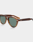 Sunglasses with tortoiseshell frame and green lenses on a light gray background. - DEI DUCHI
