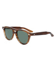 Sunglasses with tortoiseshell frame and green lenses on a light gray background. - DEI DUCHI