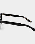 Black sunglasses with dark lenses on a light gray background. - DEI DUCHI