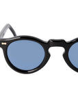 Round sunglasses with black frames and blue lenses on a light gray background. -DEI DUCHI