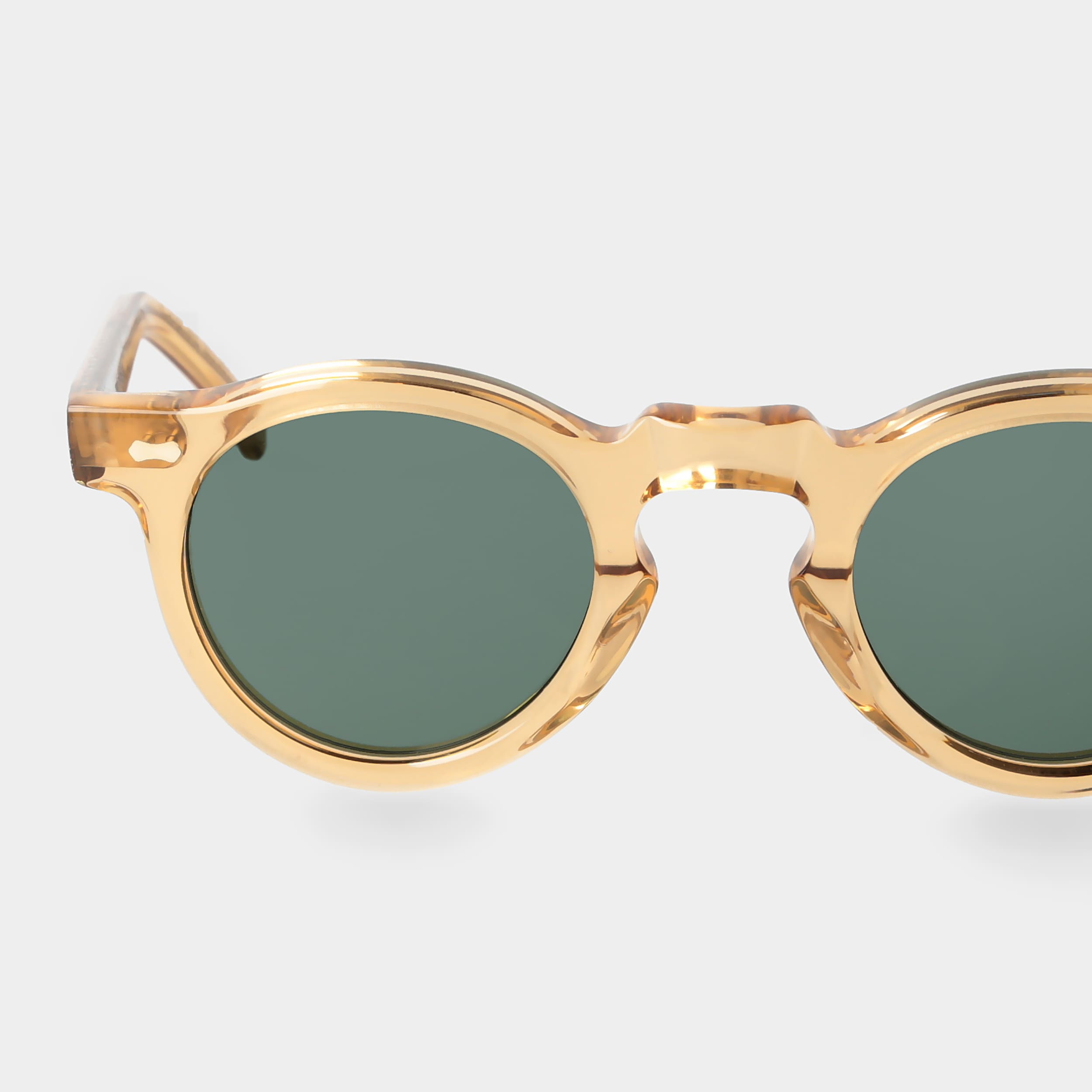 Gold-framed sunglasses with green lenses on a white background. - Dei Duchi