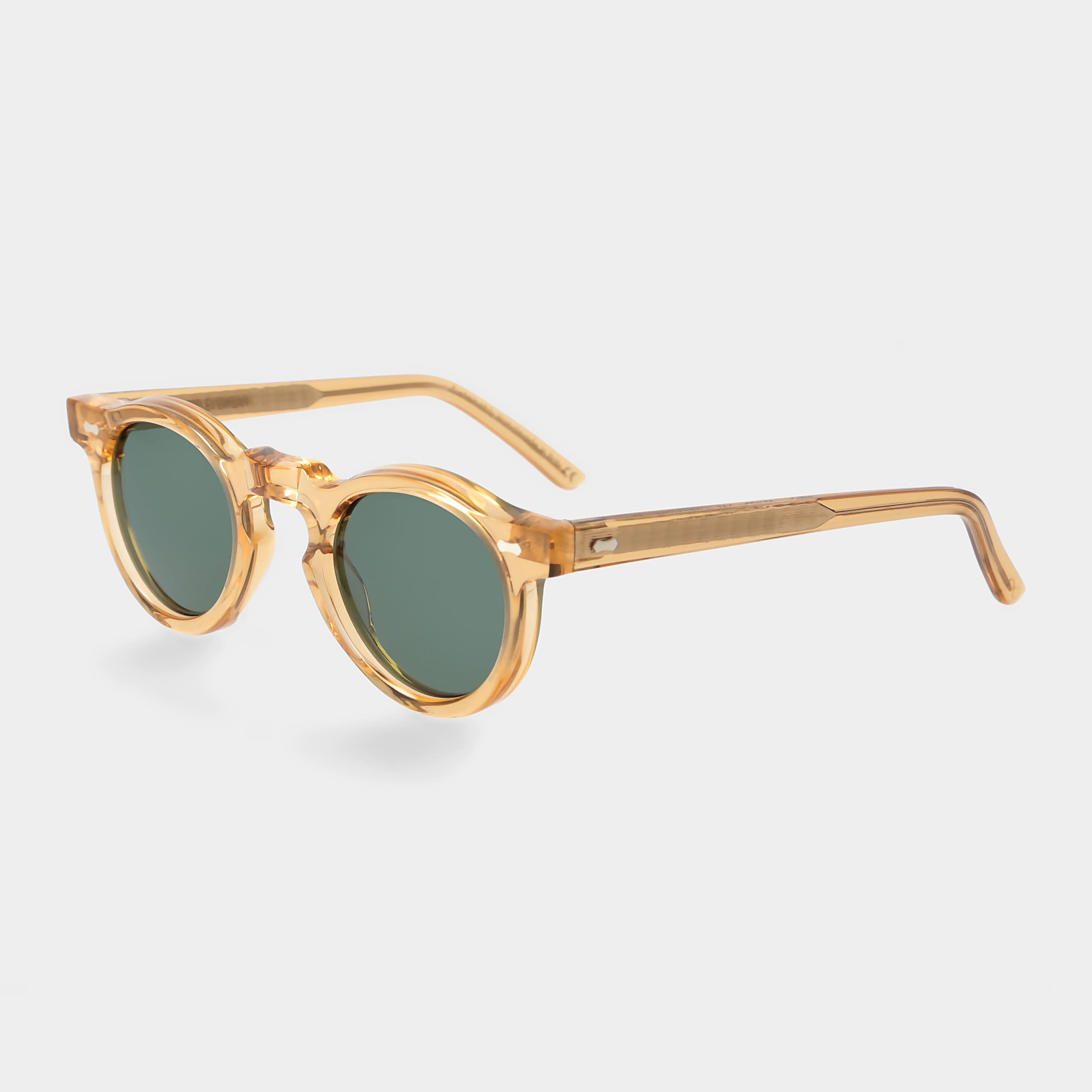 Gold-framed sunglasses with green lenses on a light gray background. - DEI DUCHI