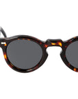 Sunglasses with tortoiseshell frame and dark lenses on a light gray background. - Dei Duchi