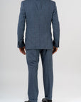 This elegant suit is made with 100% pure merino wool “Super 170s WISH” by Loro Piana. It is characterized by a checked design in shades of gray and light blue. This is a two-piece with two-button jacket with 3 pockets with flaps. One of these pockets is a watch pocket. The pants has regular rise and no darts, with american cut pockets and two back pockets. Belt with loops and zip on the front. -  Sartoria dei Duchi.