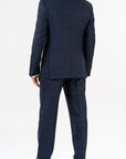 Three-piece suit, made with Loro Piana’s "Sopra Visso" wool, single-breasted,composed of a jacket with 2 buttons and welt pockets with a pocket for watch. Classic lapel and blue mother of pearl buttons. The elegant gilet has 5 buttons,the back has been made with elegant lining.The trousers have a regular waist and has only one dart,without loops with side buckle and predisposition for suspenders.Genuinely made in Italy by Sartoria dei Duchi