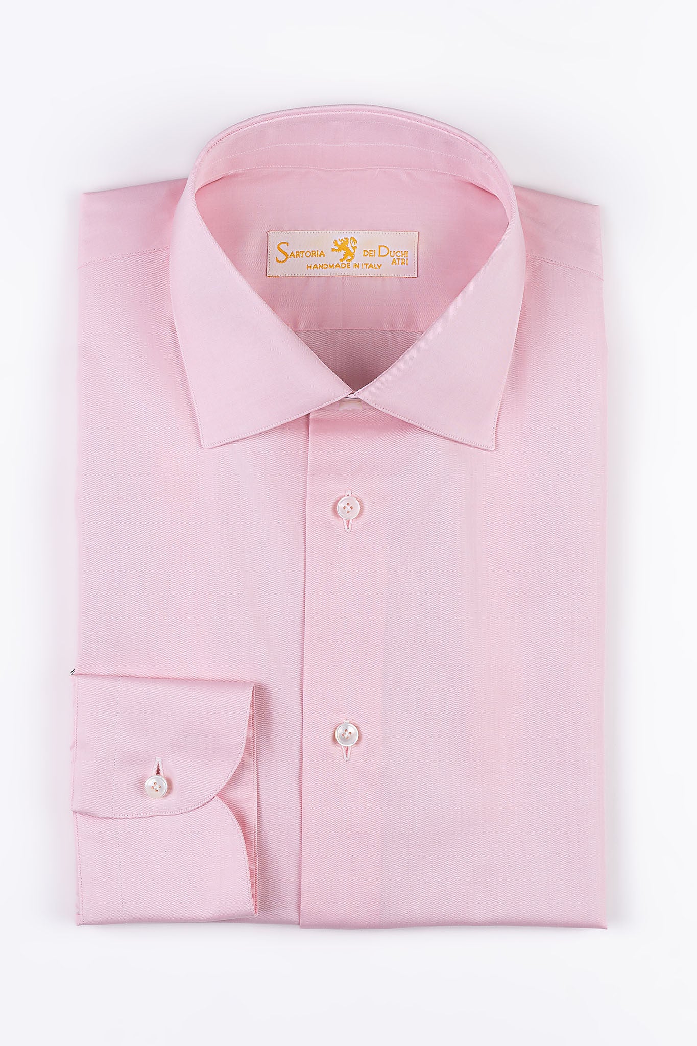 “HAMPTON SHIRT” is realized with a 140/2 cotton  twill by Thomas Mason "Hampton", in pink color.  This long sleeve shirt is made with a semi French  collar and a rounded wrist. The stitching is 5 mm  and the buttons,applied by hand,are in mother of  pearl Australia.The fit is regular-Sartoria Dei Duchi-Atri