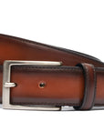 Handcrafted Antiqued Belt - Cognac. Tumbled and dyed calf leather. A 120cm waist measurement corresponds to a size 60 pant. Total belt length (including buckle) is 135cm. 3.5cm metal buckle with a brushed finish. The belt is adjustable with a screw on the back and is very easy to cut.- Sartoria Dei Duchi - Atri