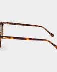 Sunglasses with tortoiseshell frame and brown lenses on a light gray background. - DEI DUCHI