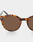 Sunglasses with tortoiseshell frame and brown lenses on a light gray background. - DEI DUCHI