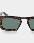 Sunglasses with tortoiseshell frame and green lenses on a light gray background. - De Duchi