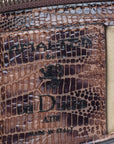 Brown textured handbag with a gold clasp on a white background. DEI DUCHI (AMALTEA)