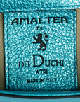 Close-up of a textured label with 'Amaltera for Dei Duchi Atri' branding on a teal background. DEI DUCHI (AMALTEA)