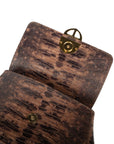 Brown textured handbag with a gold clasp on a white background. DEI DUCHI (AMALTEA)