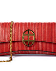 Red handbag with a chain detail, Red clutch bag with a gold emblem on a white background - DEI DUCHI (ALMATEA)