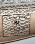 Close-up of a silvery snake textured leather bag with an ENGRAVED 'AMALTEA' branding on  a leather patch on a white background. - DEI DUCHI (AMALTEA)