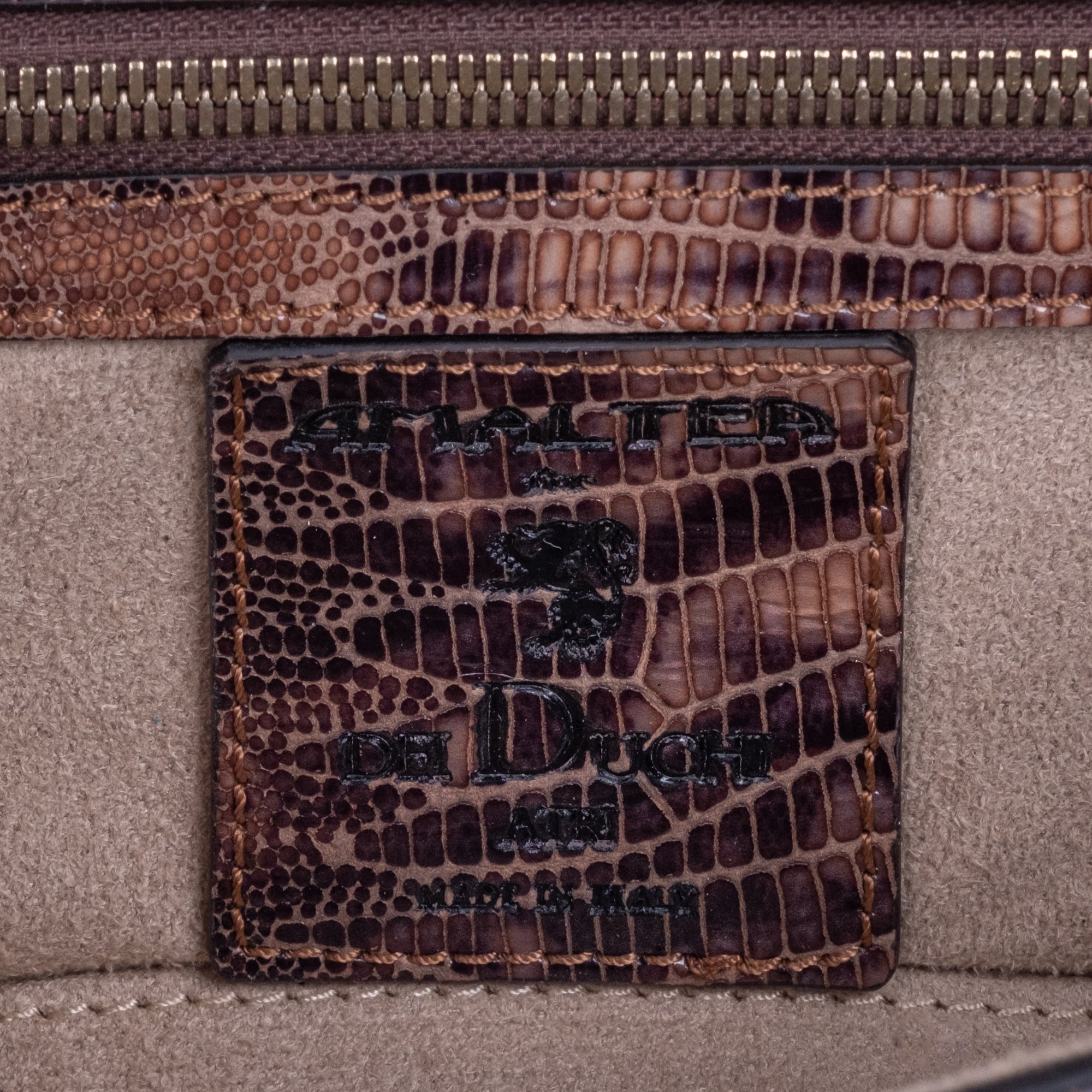 Brown embossed python skin clutch bag with gold chain and buckle/emblem on a white background. - DEI DUCHI (AMALTEA)