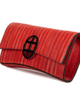 Red handbag with a chain detail, Red clutch bag with a burnished metal emblem on a white background - DEI DUCHI (ALMATEA)