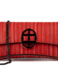 Red handbag with a chain detail, Red clutch bag with a burnished metal emblem on a white background - DEI DUCHI (ALMATEA)