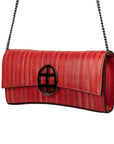 Red handbag with a chain detail, Red clutch bag with a burnished metal emblem on a white background - DEI DUCHI (ALMATEA)
