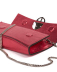 Red handbag with a chain detail, Red clutch bag with a gold emblem on a white background - DEI DUCHI (ALMATEA)